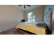 Bedroom with neutral carpet, ceiling fan, and large window at 3552 Macauley Ct, Ocoee, FL 34761