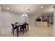 Open dining area with tile flooring, chandelier lighting, and a view of the kitchen bar at 3552 Macauley Ct, Ocoee, FL 34761