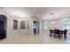 Open concept dining area with tile floors, sliding glass door, and modern lighting at 3552 Macauley Ct, Ocoee, FL 34761