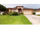 Well-maintained single-Gathering home featuring a manicured lawn and a two-car garage at 3552 Macauley Ct, Ocoee, FL 34761
