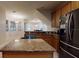 Open concept kitchen with granite countertops, stainless steel appliances, and an island, perfect for modern living at 3552 Macauley Ct, Ocoee, FL 34761