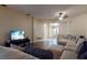 Inviting living room with hardwood floors, comfortable seating, and a modern TV at 3552 Macauley Ct, Ocoee, FL 34761