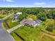 Aerial view highlighting the property with a screened-in pool, and a large backyard bordered by mature trees at 3750 Oak Pointe Blvd, Kissimmee, FL 34746