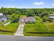 Expansive aerial view showcases the home's generous lot size and lush green landscaping with mature trees at 3750 Oak Pointe Blvd, Kissimmee, FL 34746