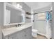 Clean bathroom with gray vanity, granite countertop, and tiled shower at 3750 Oak Pointe Blvd, Kissimmee, FL 34746