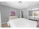 A bright bedroom with gray walls and a mirrored closet at 3750 Oak Pointe Blvd, Kissimmee, FL 34746