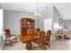 Traditional dining room features elegant chandelier, tile flooring, and a large wood china cabinet at 3750 Oak Pointe Blvd, Kissimmee, FL 34746