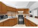 Well-equipped kitchen with updated appliances, ample counter space, and abundant wood cabinetry storage at 3750 Oak Pointe Blvd, Kissimmee, FL 34746