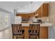 Efficient kitchen features ample wood cabinetry, a breakfast bar, and access to the outdoor pool area at 3750 Oak Pointe Blvd, Kissimmee, FL 34746
