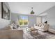 Bright living room with large window, neutral walls, tile floor, and comfortable seating creating an inviting atmosphere at 3750 Oak Pointe Blvd, Kissimmee, FL 34746