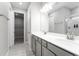 Bright bathroom featuring double sinks, modern fixtures, gray cabinets, and tiled floors at 4028 Southern Vista Loop, St Cloud, FL 34772