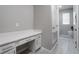 Desk area with drawers and cabinets, leading to the laundry room at 4028 Southern Vista Loop, St Cloud, FL 34772