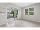 Bright dining area with sliding glass doors to a screened lanai and tiled floors at 4028 Southern Vista Loop, St Cloud, FL 34772