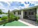 Exterior view with patio, manicured lawn, and screened in porch at 4028 Southern Vista Loop, St Cloud, FL 34772