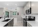 Open kitchen featuring stainless steel appliances, a breakfast bar, and tile backsplash at 4028 Southern Vista Loop, St Cloud, FL 34772