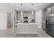 Modern kitchen featuring stainless steel appliances, a center island with quartz countertops, and stylish pendant lighting at 4028 Southern Vista Loop, St Cloud, FL 34772