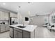 Open kitchen featuring stainless appliances, a breakfast bar, pendant lighting, and tile floors at 4028 Southern Vista Loop, St Cloud, FL 34772
