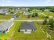 Aerial view showcasing a home's backyard with a lush lawn and newly built construction in a neighborhood at 4662 Sw 136Th St, Ocala, FL 34473