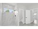 Bathroom with marble tile shower, white vanity, and modern finishes at 4662 Sw 136Th St, Ocala, FL 34473
