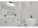 Bathroom with a standalone tub, dual vanity, and modern fixtures at 4662 Sw 136Th St, Ocala, FL 34473