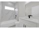 Modern bathroom featuring a marble-tiled shower, sleek fixtures, and a white vanity at 4662 Sw 136Th St, Ocala, FL 34473