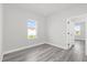 Bright bedroom with wood-look flooring and a view from the window at 4662 Sw 136Th St, Ocala, FL 34473