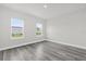 Bright bedroom with two large windows and gray vinyl flooring at 4662 Sw 136Th St, Ocala, FL 34473