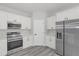 Well-equipped kitchen boasts stainless steel appliances and sleek white cabinets at 4662 Sw 136Th St, Ocala, FL 34473
