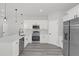 Well-lit kitchen featuring stainless steel appliances and a center island with a sink and faucet fixture at 4662 Sw 136Th St, Ocala, FL 34473