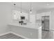 Bright, modern kitchen featuring stainless steel appliances, white cabinetry, and a spacious quartz countertop island at 4662 Sw 136Th St, Ocala, FL 34473