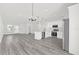 An open-concept kitchen and dining room with modern white cabinets and stainless steel appliances at 4662 Sw 136Th St, Ocala, FL 34473