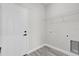 The modern laundry room features a utility sink, shelving, and neutral paint at 4662 Sw 136Th St, Ocala, FL 34473
