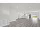 An open-concept living room features gray floors, recessed lighting, and an open kitchen at 4662 Sw 136Th St, Ocala, FL 34473