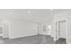 The open-concept living room features gray floors, recessed lights, and a view of the front door at 4662 Sw 136Th St, Ocala, FL 34473
