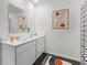 Bright bathroom featuring dual sinks, a large mirror, and modern decor accents at 5120 Gopher Apple Dr, Apopka, FL 32712