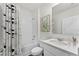 Clean bathroom with white tile, a shower-tub combination, and contemporary fixtures at 5120 Gopher Apple Dr, Apopka, FL 32712
