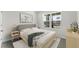 Cozy bedroom with a modern bed, minimalist decor, and a large window for natural light at 5120 Gopher Apple Dr, Apopka, FL 32712