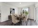 Bright dining room with a modern table, stylish chairs, and a large window overlooking the yard at 5120 Gopher Apple Dr, Apopka, FL 32712