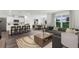 Open-concept living area featuring a modern kitchen, dining space, and cozy seating area with large windows at 5120 Gopher Apple Dr, Apopka, FL 32712