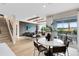 Open-concept living and dining area with modern decor and outdoor patio access at 5530 Settlingstone Ln, St Cloud, FL 34771
