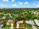 An aerial view of a home features a well-maintained lawn, mature trees, and a layout with a pool in the neighborhood at 7040 Betty St, Winter Park, FL 32792