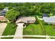 An aerial view of a single-story home with a well-manicured lawn and mature trees in a quiet neighborhood at 7040 Betty St, Winter Park, FL 32792