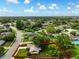 A serene aerial view of a home with mature trees showcases the property's sprawling green lawn and neighborhood streets at 7040 Betty St, Winter Park, FL 32792