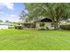 This home features a spacious backyard with a large tree and a screened patio, perfect for outdoor entertaining at 7040 Betty St, Winter Park, FL 32792