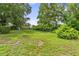 This large backyard is surrounded by lush trees and greenery, offering privacy and a peaceful outdoor space at 7040 Betty St, Winter Park, FL 32792