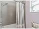 Bathroom featuring tiled walls, shower head, and a window bringing in natural light at 7040 Betty St, Winter Park, FL 32792