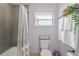 The bathroom features tiled walls, a shower-tub combination, and ample storage for a clean and fresh aesthetic at 7040 Betty St, Winter Park, FL 32792