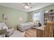 Bright bedroom with neutral walls, a comfortable bed, and a spacious desk area, perfect for relaxation and productivity at 7040 Betty St, Winter Park, FL 32792