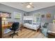 This bedroom features a bunk bed, a desk, and wood-look flooring, creating a cozy and functional space at 7040 Betty St, Winter Park, FL 32792