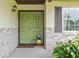 A close-up of a charming front door with brick accents and lovely landscaping adding curb appeal at 7040 Betty St, Winter Park, FL 32792